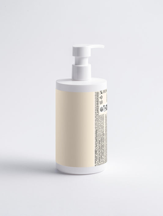 White bottle with beige label on a light gray background