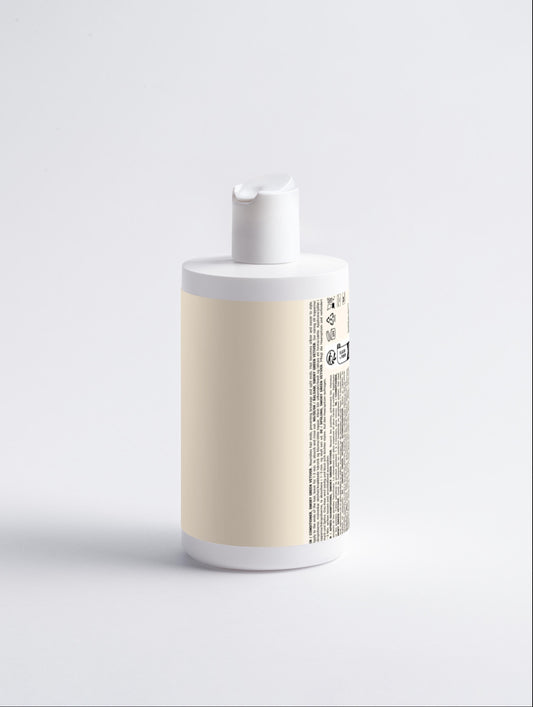 White and beige bottle with a label on a light gray background