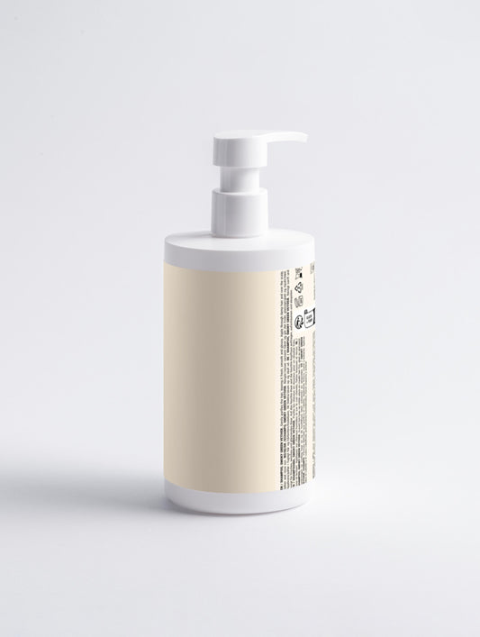 White bottle with beige label on a light gray background