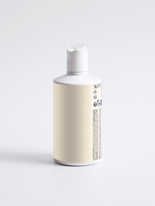 White bottle with a beige label on a light gray background